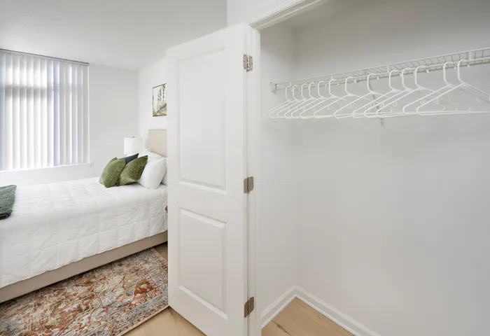 Ellington One Bedroom walk-in closet featuring new wood-style vinyl plank flooring | Meridian at Grosvenor Station | Luxury North Bethesda MD Apartments | Luxury Rockville MD Apartments
