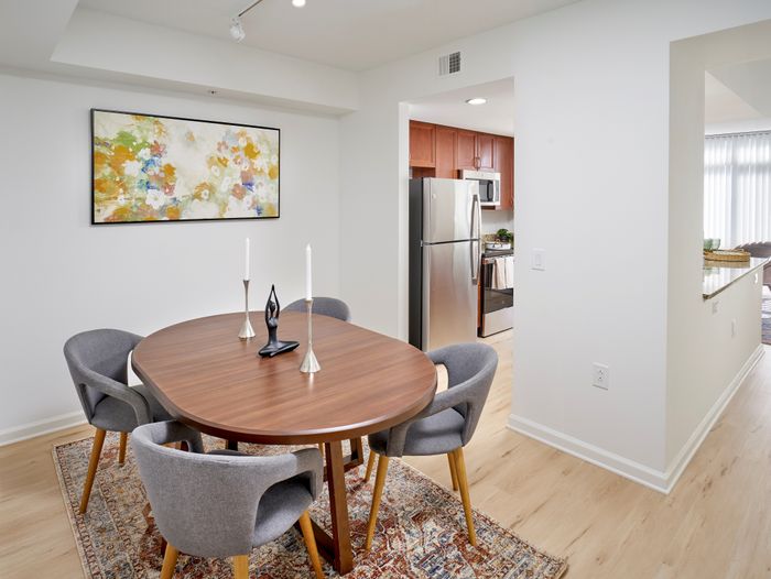 Renovated dining nook in the Ellington One Bedroom floor plan featuring new wood-style vinyl flooring and modern overhead lighting | Meridian at Grosvenor Station | Luxury North Bethesda MD Apartments | Luxury Rockville MD Apartments