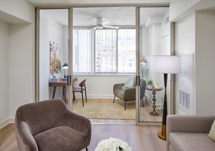 Renovated one bedroom apartment with sunroom at Meridian at Eisenhower Station with granite countertops, stainless steel appliances, wood-style flooring, and updated lighting and other features | Alexandria VA Apartments | Luxury Alexandria VA Apartments
