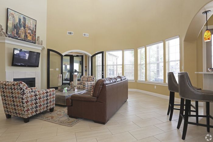 Spacious clubhouse with high ceilings, modern decor, and ample natural light.