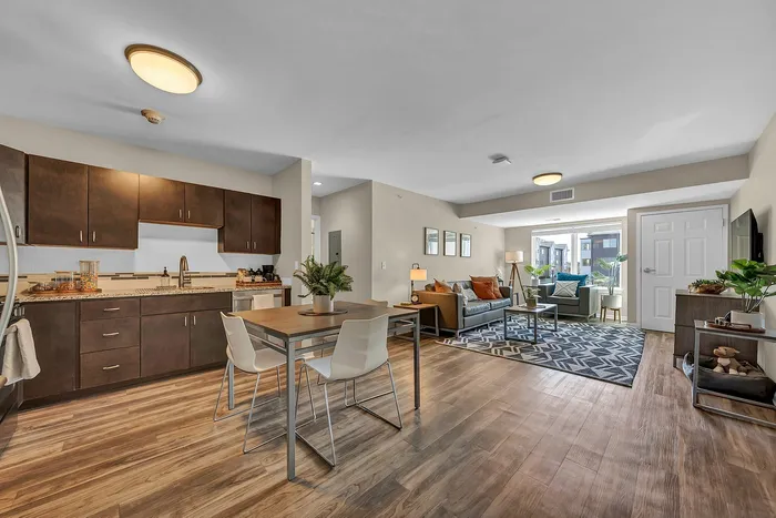 Modern open-concept apartment in Buffalo NY with a full modern kitchen, inviting dining area, and a cozy living room.