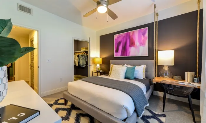 Apartments near Piedmont Atlanta Hospital - The Kendrick - Bedroom with a Spacious Closet, Carpeting, and a Study Desk Area