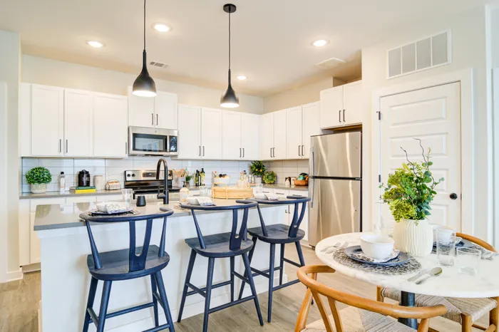 Model dining area and kitchen at Cadence Sugar Hill, Sugar Hill, GA 30518