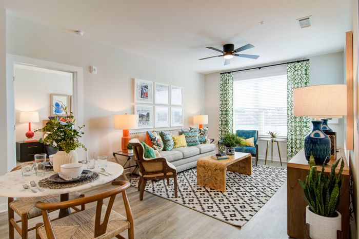 Apartments for Rent in Sugar Hill, GA - Cadence Sugar Hill - Living Room with Ceiling Fan, Large Window, and Dining Area