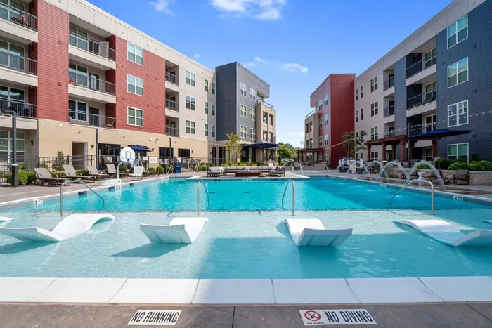 Resort style swimming pool with cabanas at The Parq at Chesterfield Apartment Homes, Chesterfield, MO 63017