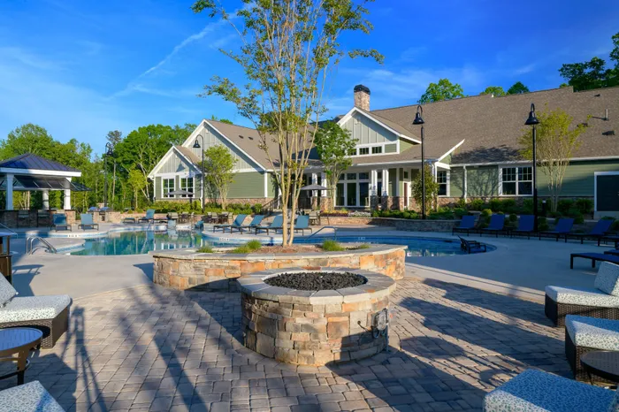 Athens, GA Apartments Near University of Georgia - Lullwater at Jennings Mill - Expansive Sundeck With Comfy Seating, A Firepit, and A View of the Pool