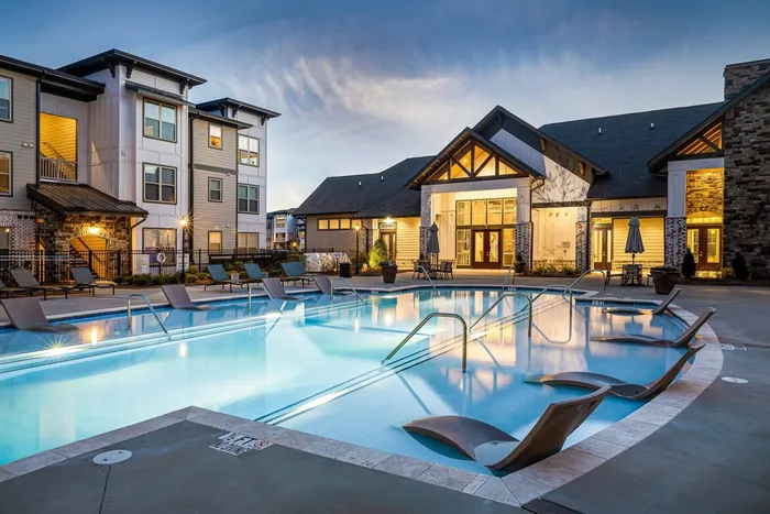 Apartments in Buford, GA for Rent - The Harrison at Braselton - Resort-Style Pool with Lounge Chairs in the Water, Tanning Chairs, Chairs and Umbrellas with Access to the Clubhouse