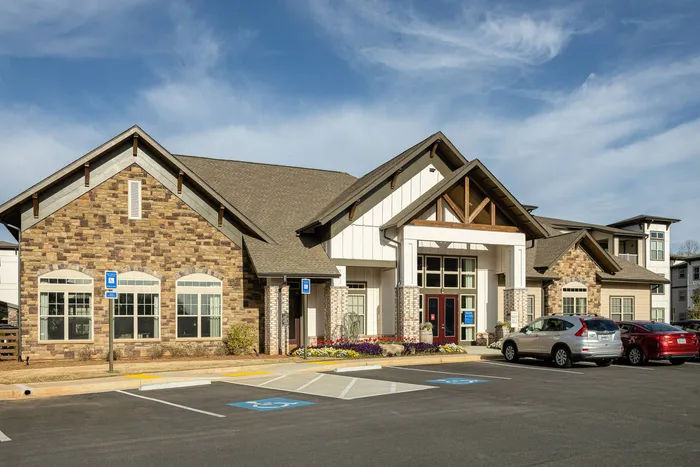 Pet-Friendly Apartments in Buford, GA - The Harrison at Braselton - Leasing Office with Parking, Windows, and Red Door.