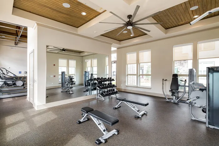 Buford, GA, Apartments Near Lake Lanier - The Harrison at Braselton - Fitness Center with Rubber Matting, Large Mirror, Strength Equipment, Weights, Ceiling Fan, and Recessed Lighting