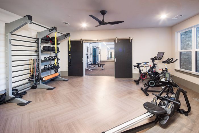 Dog-Friendly Apartments in Gainesville, GA - The Mill at New Holland - Fitness Center with Stationary Bikes, Free Weights, and Row Machine