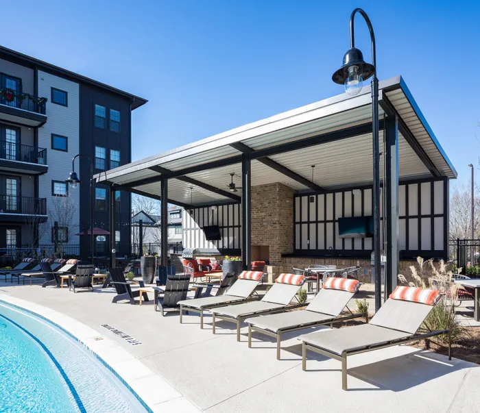 Dog-Friendly Apartments in Gainesville, GA - The Mill at New Holland - Pool-Side Sun Shelf with Lounge Seats, Tables and Chairs, BBQ Station, and Outdoor Kitchen.
