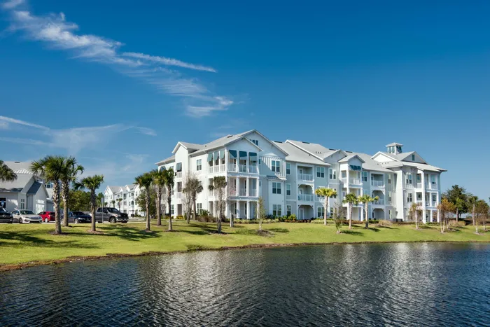 apartment buildings and lake on sunny day