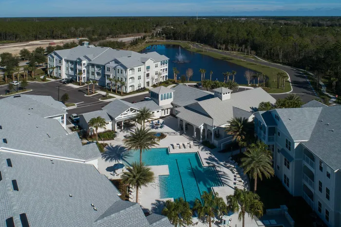aerial oh apartment buildings and pool on sunny day