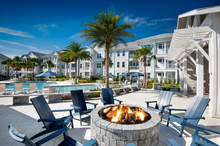 upclose of fire pit and pool and apartment buildings on sunny day