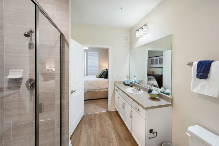 bathroom with glass doors and sink