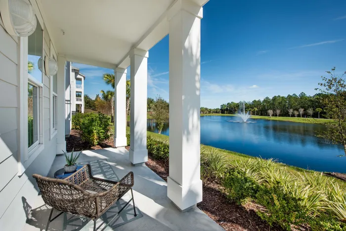 patio with furniture overlooking lake on sunny day