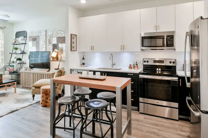 Gorgeous kitchen with designer gold hardware and two-toned cabinets at Park 35 Birmingham AL 35222