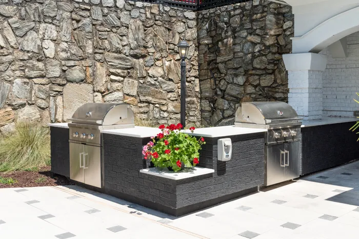 Apartments for rent Pine Hills Atlanta, GA - The Kendrick - BBQ Grilling Station with a Stone Wall, Quartz Countertops, and Tile Floors