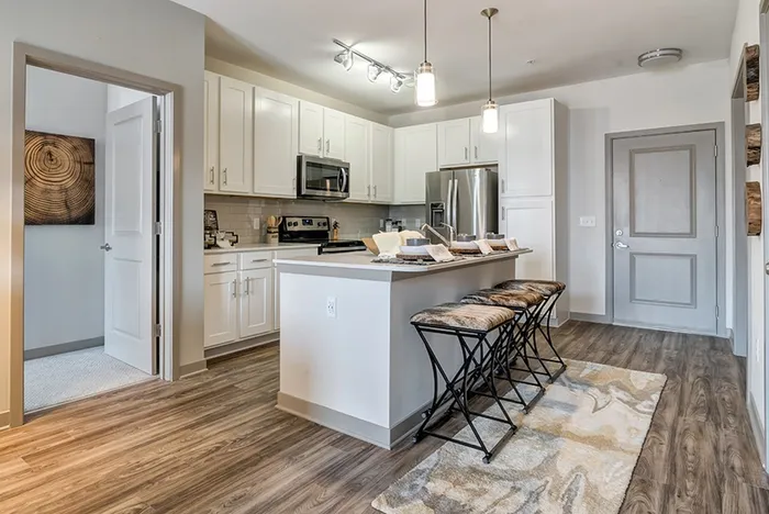 Kitchen island wiuth 3 place settings and chairs