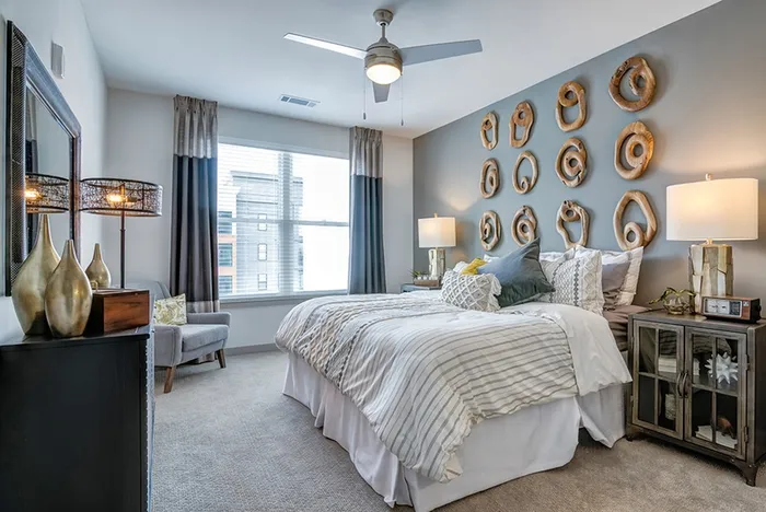 Bedroom with ceiling fan and large window