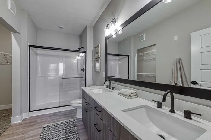 secondary model bathroom with enclosed shower Encore Apartments Belton MO