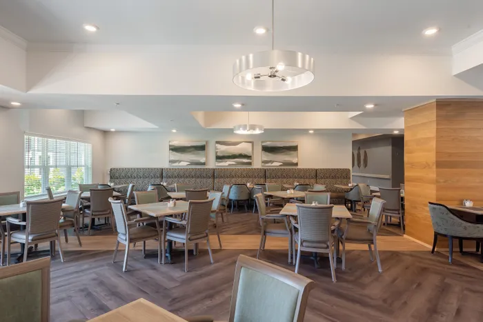 Elegant dining area with modern lighting, cozy seating, and artistic decor, offering a warm and inviting ambiance.
