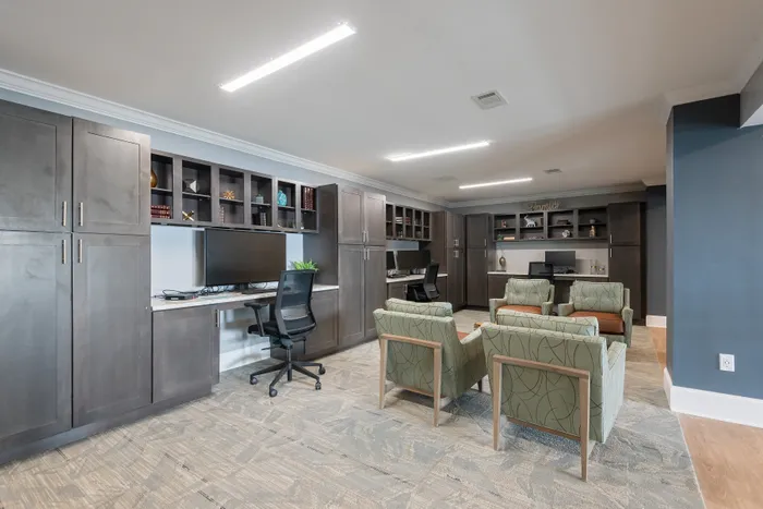 Modern office space with stylish seating, sleek dark cabinets, and spacious workstations, perfect for productivity and collaboration.