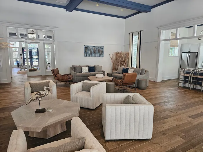 Elegant living room with modern decor, plush seating, and stylish wood flooring, perfect for relaxation and entertaining.