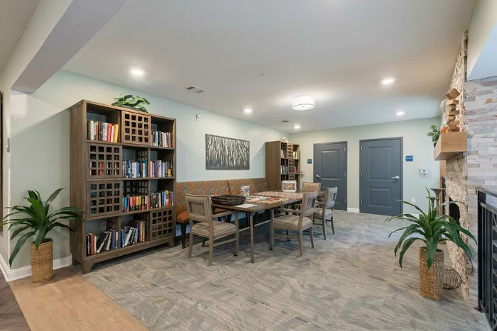 Charming apartment lounge with cozy seating, a stylish bookshelf, and inviting decor around a warm fireplace.