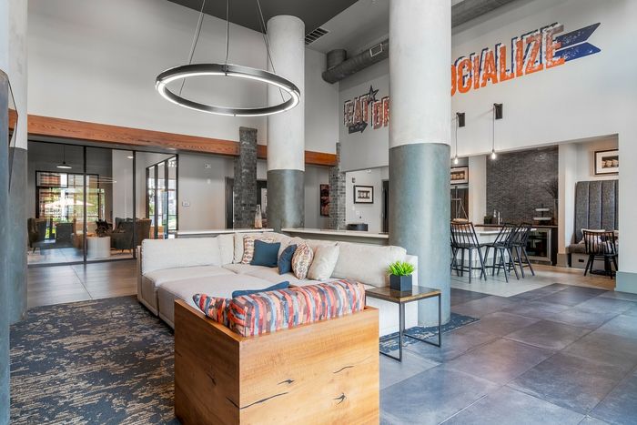 Inviting modern lobby with elegant seating, chic lighting, and cozy dining area.