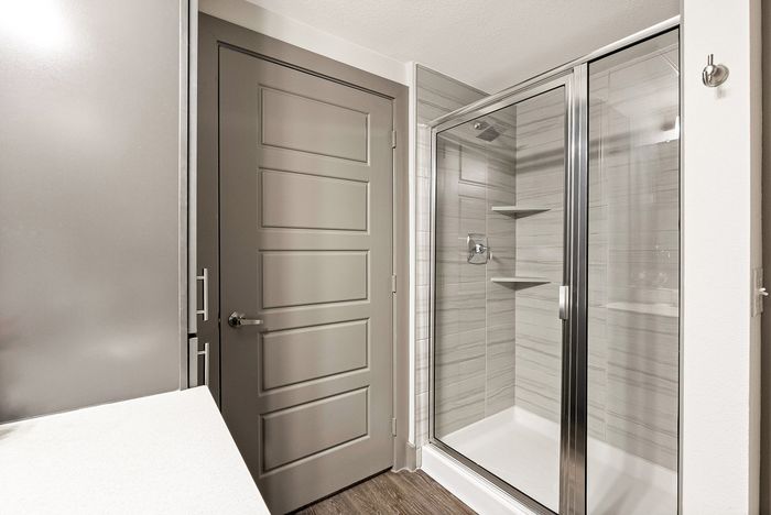 Elegant bathroom design featuring a modern glass shower enclosure with sleek tiled walls and stylish cabinetry.