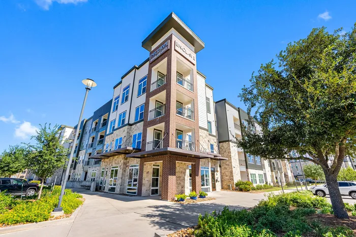 Modern apartment complex showcasing stylish architecture, lush landscaping, and ample natural light.