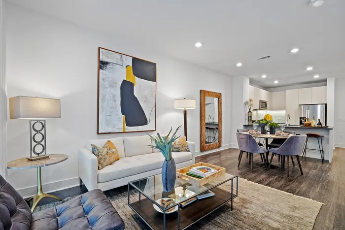 Modern living space featuring a stylish open-concept layout with elegant decor, cozy seating, and a sleek kitchen, perfect for entertainment.