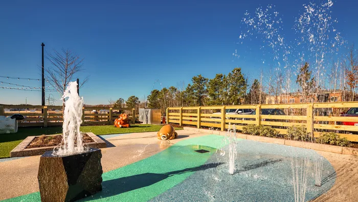 Charming outdoor space featuring playful water fountains, vibrant animal sculptures, and a sunny backdrop for family enjoyment.