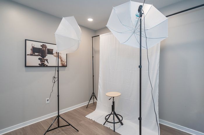 Bright and inviting in-home studio space featuring professional lighting, backdrop, and modern decor.