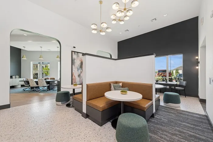 Modern co-working space featuring elegant seating areas, stylish lighting fixtures, and a vibrant, contemporary design.