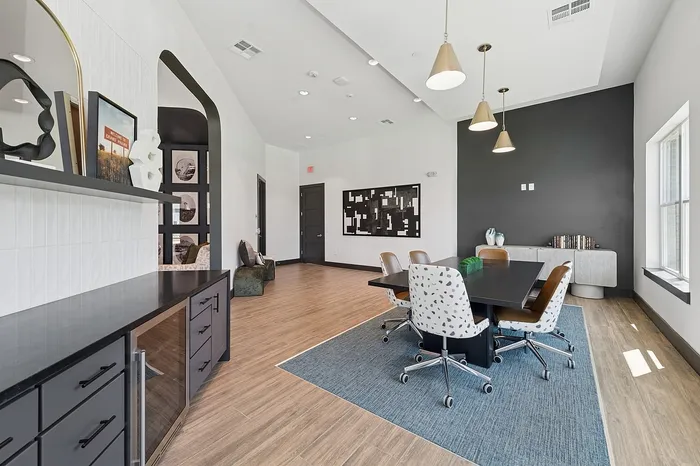 Contemporary meeting room with elegant design, featuring modern lighting, stylish furniture, and natural wood flooring.