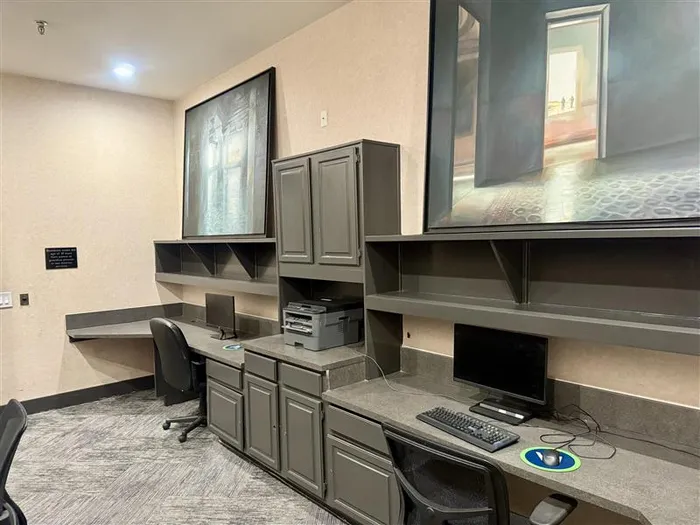 Modern office space with sleek desks, stylish chairs, and contemporary art for a productive environment.