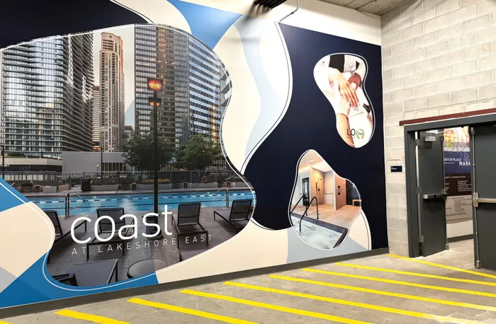 Vibrant promotional wall for Coast at Lakeshore East showcasing luxury city living with a pool view, spa services, and modern amenities.