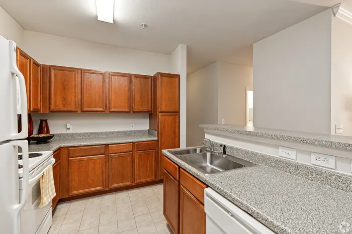Charming kitchen featuring rich wooden cabinetry, elegant granite countertops, and modern appliances.