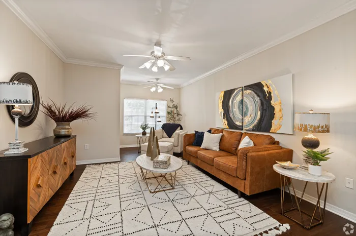 Elegant living room featuring a luxurious leather sofa, stylish modern decor, and abundant natural light creating a warm, inviting atmosphere.