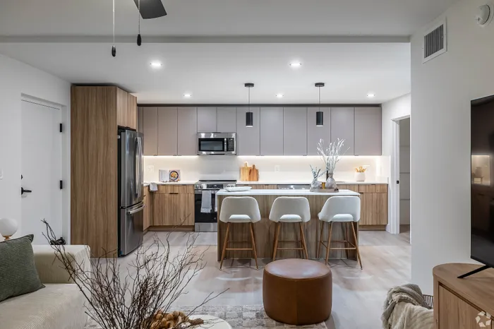 Modern kitchen with sleek cabinetry, stainless steel appliances, and stylish bar seating, perfect for contemporary living.