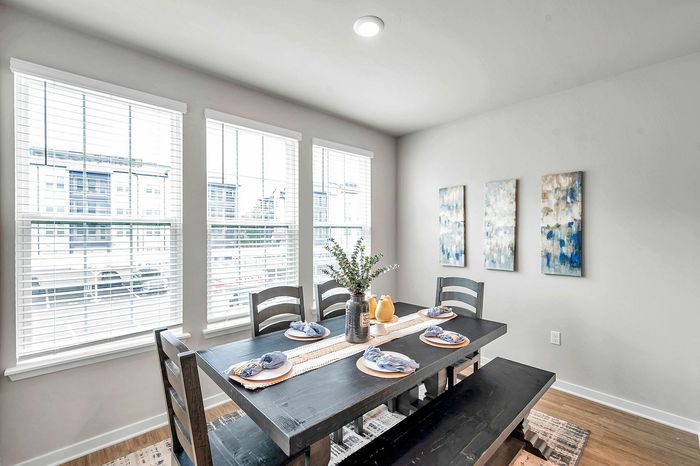 Bright and modern dining area with chic decor and large windows for abundant natural light.