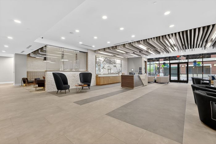 Modern lobby with sleek design featuring stylish seating, elegant lighting, and a contemporary reception desk welcoming guests.