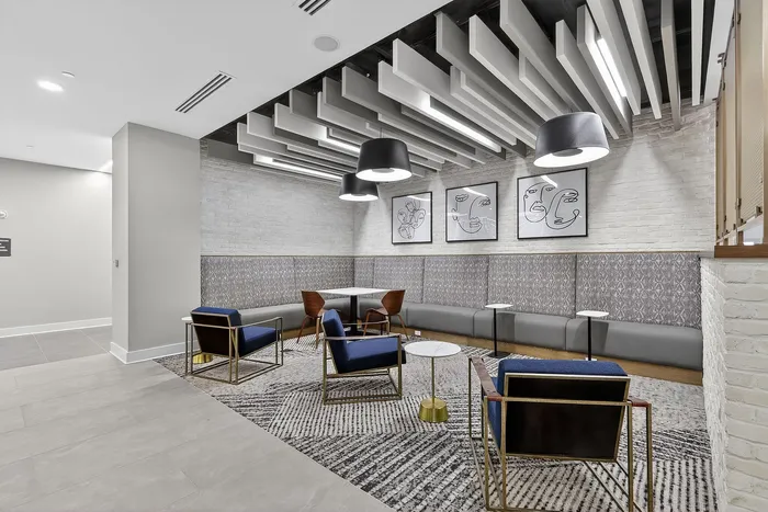 Chic and modern common area with stylish seating, artistic wall decor, and unique ceiling designs, creating a sophisticated atmosphere.