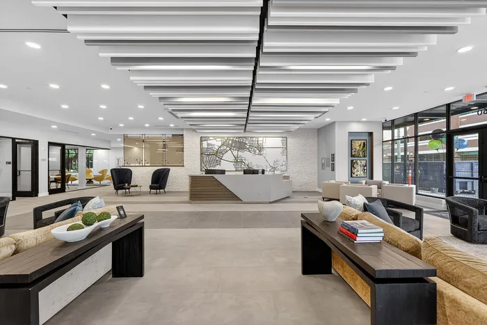 Modern apartment lobby with sleek design, stylish furniture, and a sophisticated reception area.