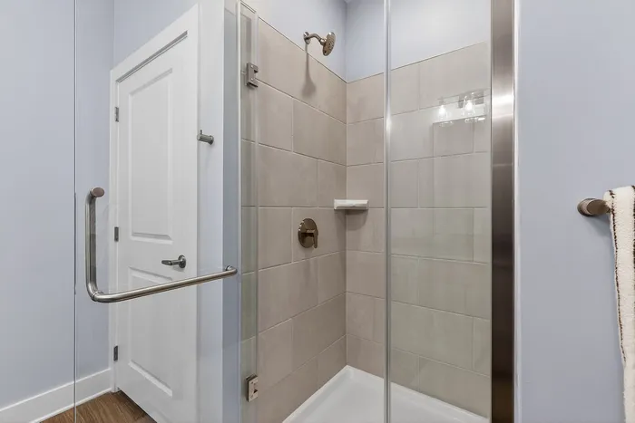 Contemporary bathroom with elegant glass shower door and modern fixtures, offering a sleek and polished look.