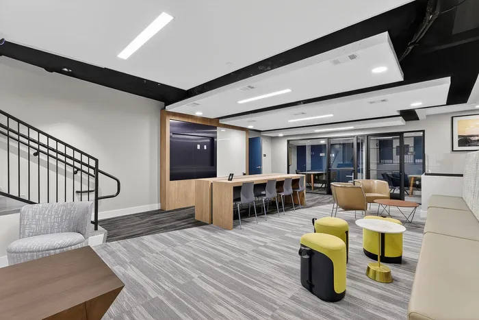 Modern communal lounge featuring sleek furniture, ample seating, and stylish decor for a comfortable living experience.