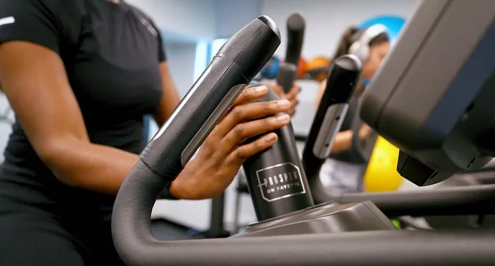 Modern gym equipment being actively used in a vibrant fitness room, showcasing a dynamic and healthy lifestyle.