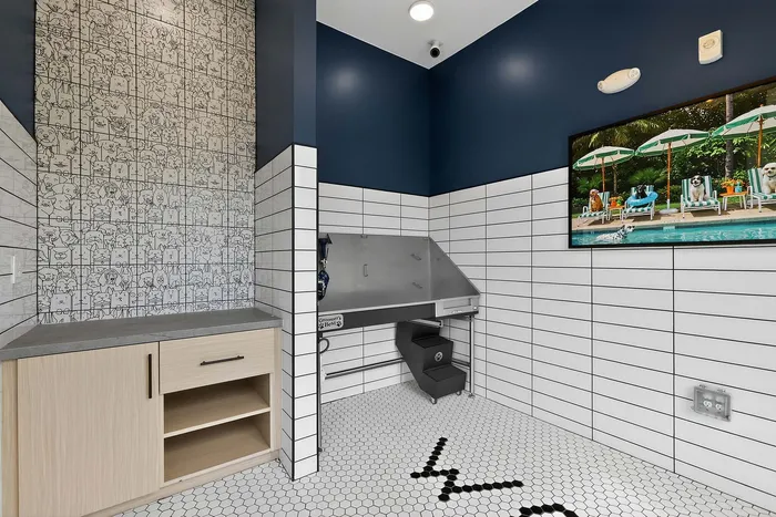Chic pet grooming area with playful wall art, practical cabinetry, and a modern washing station, perfect for pet-friendly living.